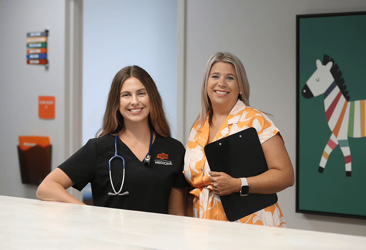 Dr. Heather Rector and physician Kendall Ferguson working at the OSU Medicine pediatrics clinic.