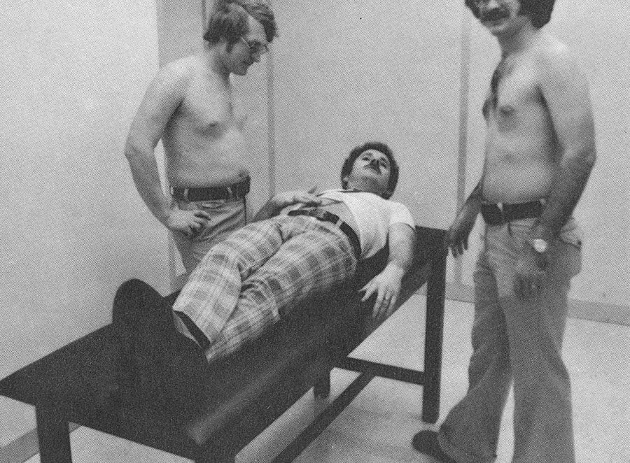 historic photo of students performing small health exams