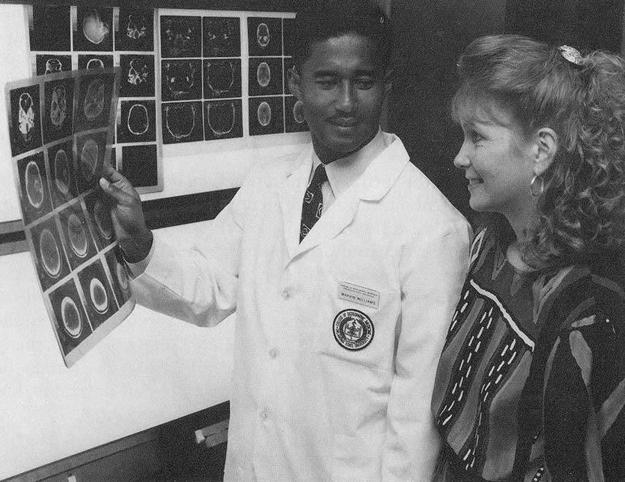 1990s-main-v1.jpg Student reviews details of a radiology slide