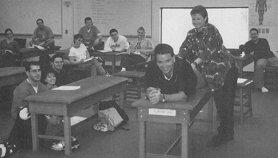 MS I students observe as Dr. Dyer illustrates techniques on resident doctor, Jonathan Scott Clark.
