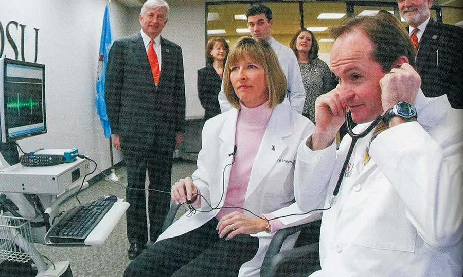 Congressman John Sullivan checks out his heart beat using telemedicine technology during a visit to canpus. Sullivan has championed OSU’s telemedicine growth. Assisting him is Sheryl Stansifer.