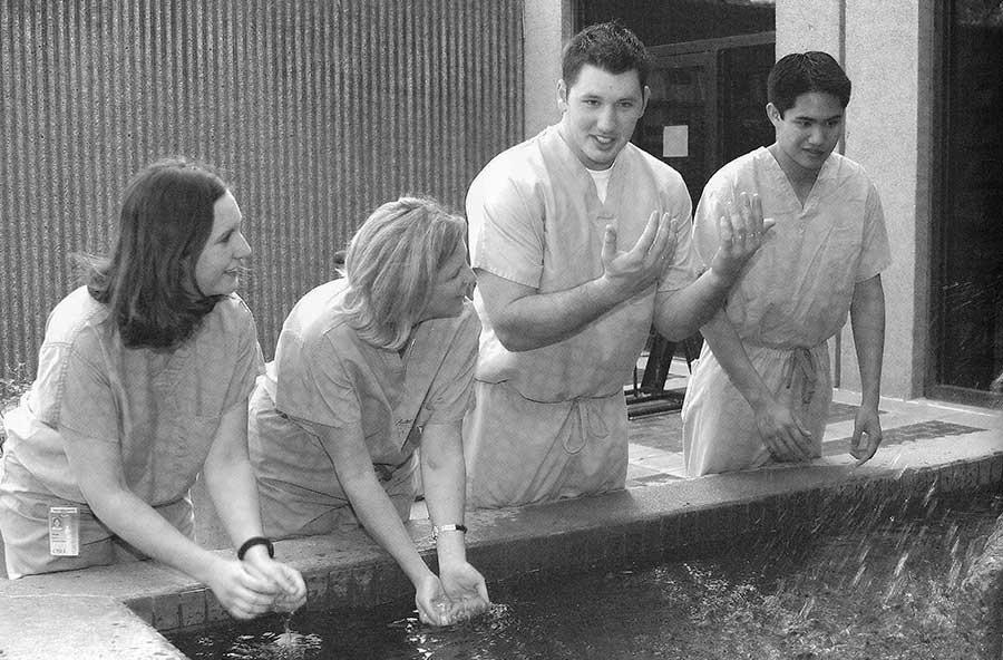 Shonda Davis, Patrice Wagner, Kevin Dare and Ricard Le demonstrate techniques of scrubbing for surgery.