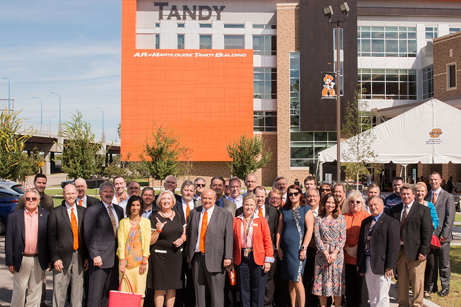 Alumni gather outside the Tandy Building on campus. Alumni gather outside the Tandy Building on campus.