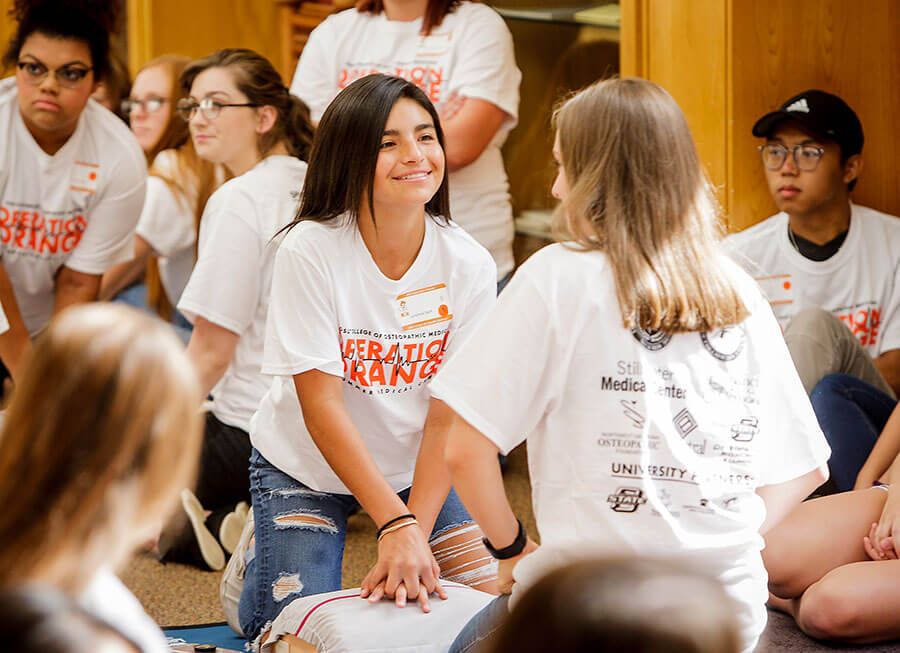 2010s-gallery11.jpg Students practice chest compressions during an Operation Orange event.