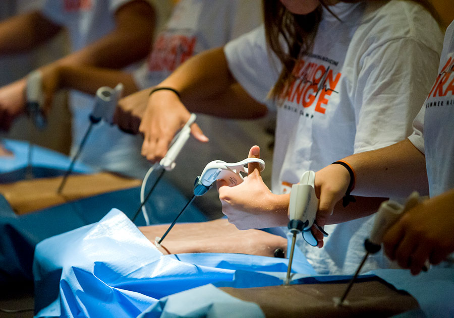 Students practice medical techniques including laparoscopy during an Operation Orange event. Students practice medical techniques including laparoscopy during an Operation Orange event.