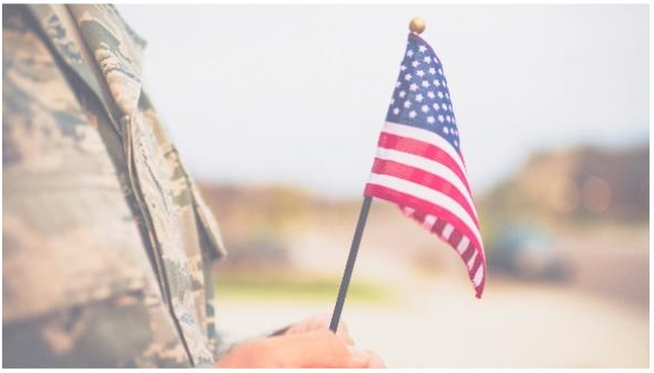 solider holding the American flag