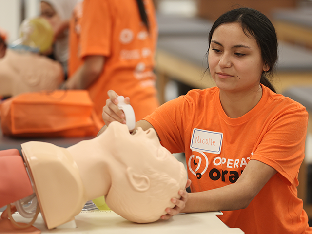 High school med school prospect participating in the airway management station at Operation Orange in Tulsa, Oklahoma. High school med school prospect participating in the airway management station at Operation Orange in Tulsa, Oklahoma.